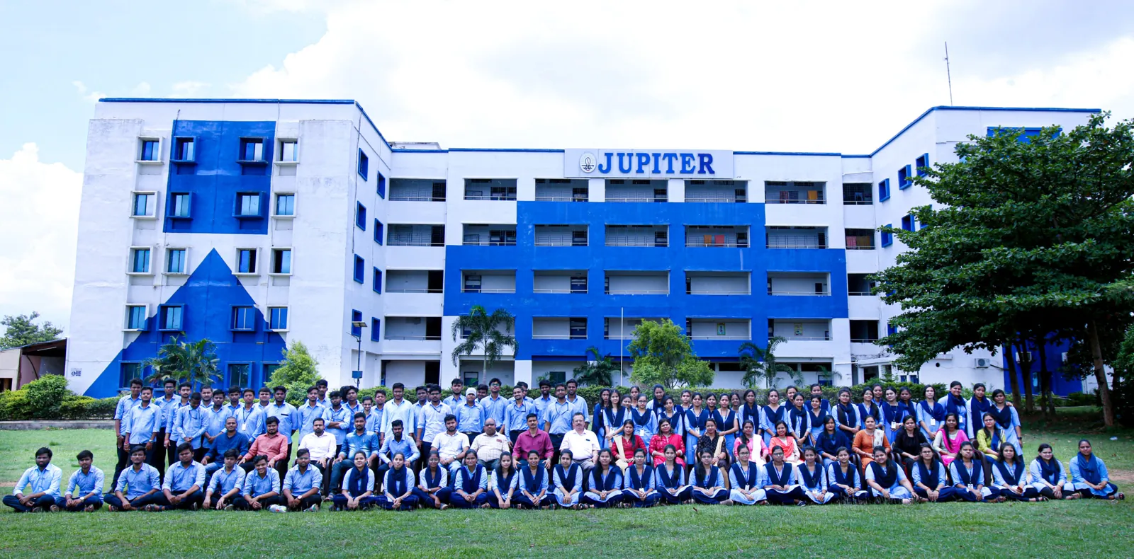 Students gathered on the lawn in front of the Jupiter college building.